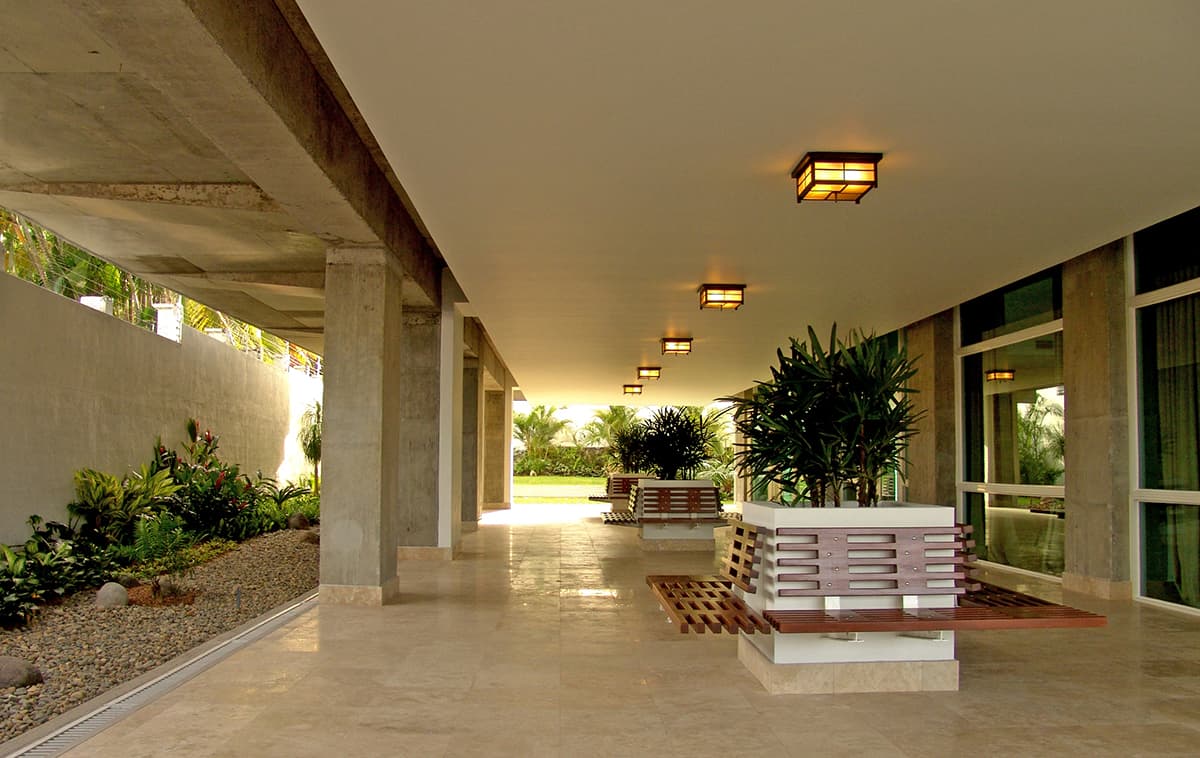 Covered walkway with stone floor at the PH Pradera ground level
