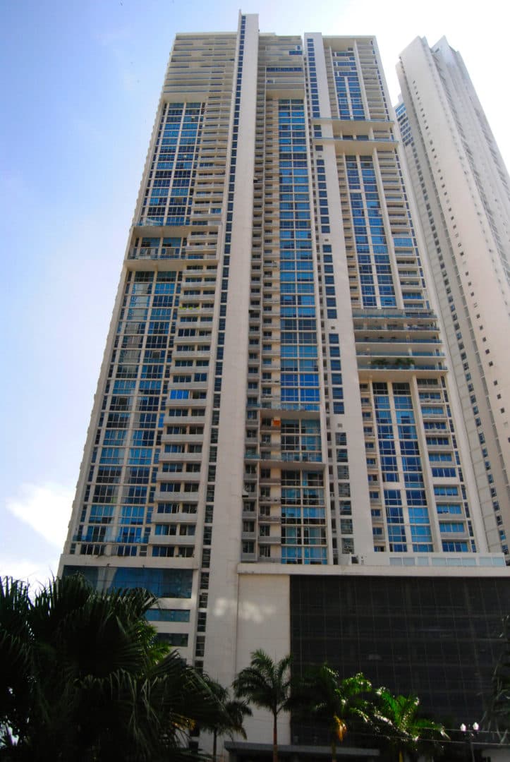 Photograph of the Aqualina tower rising above the palms on Calle Punta Colón, Punta Pacifica, Panama City