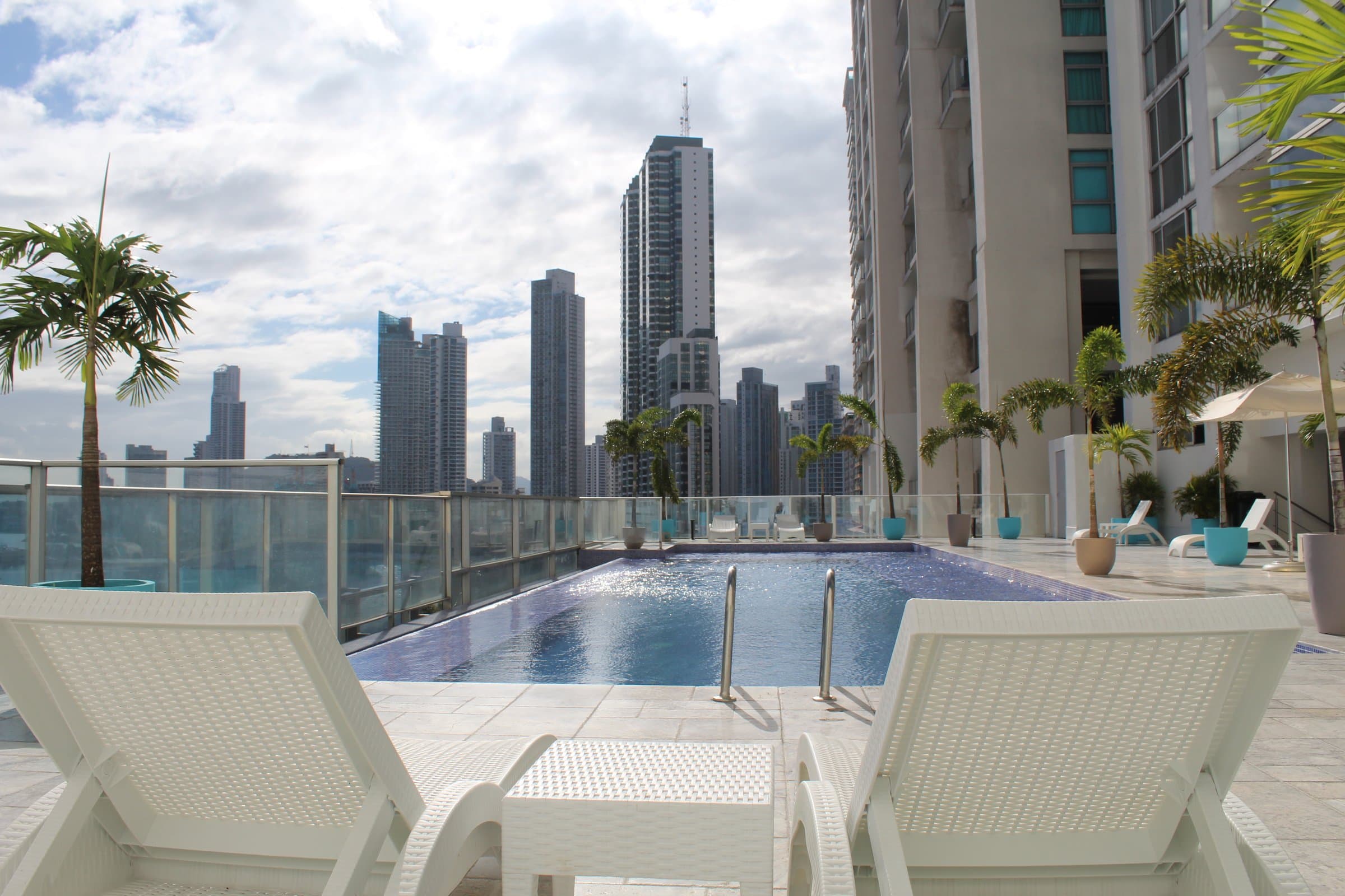 Waters on the Bay rooftop pool deck with loungers and the Panama City skyline