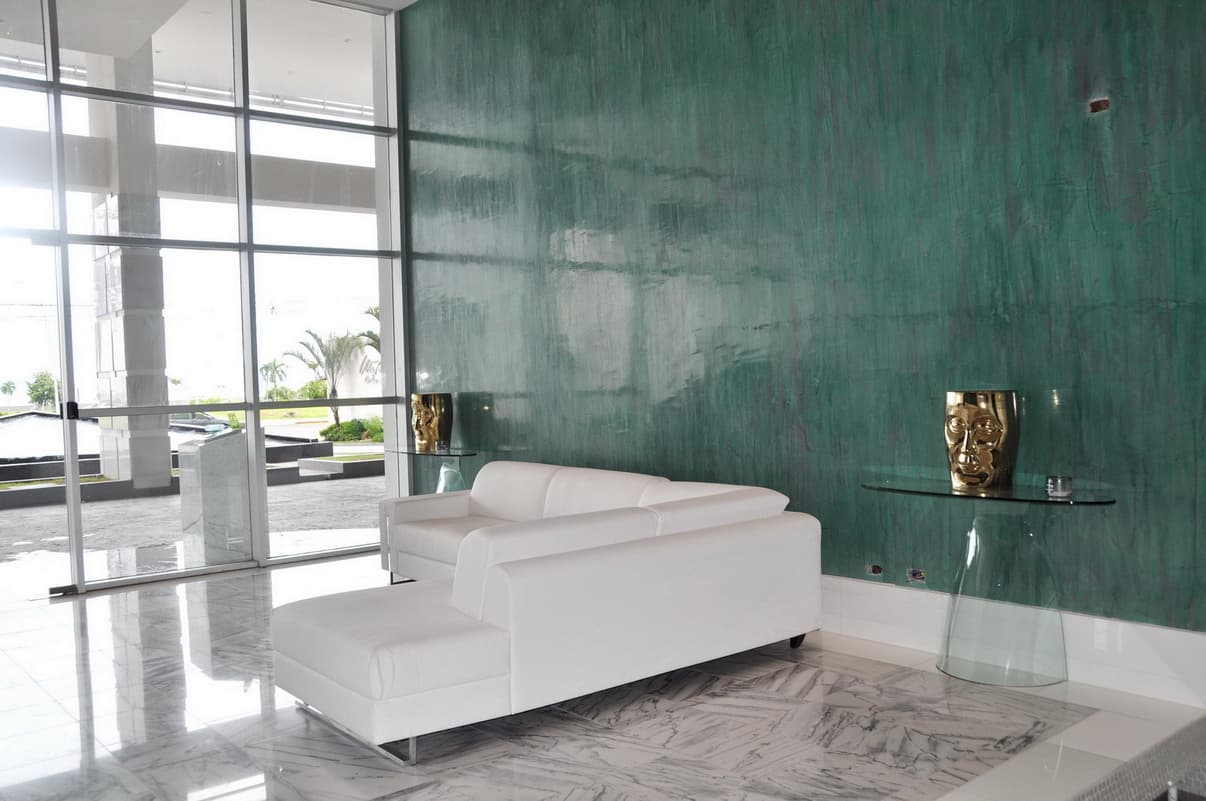 Waters on the Bay lobby lounge with white sofas and a green feature wall