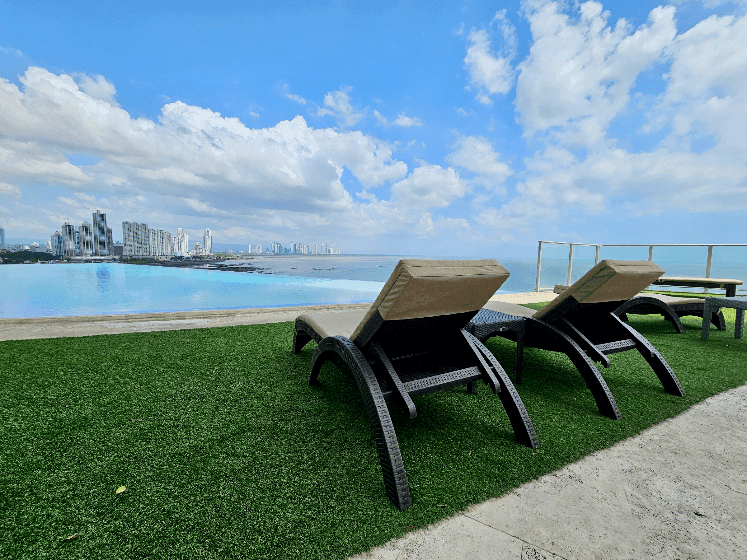 Oasis on the Bay oceanfront infinity pool with loungers and the Panama City skyline