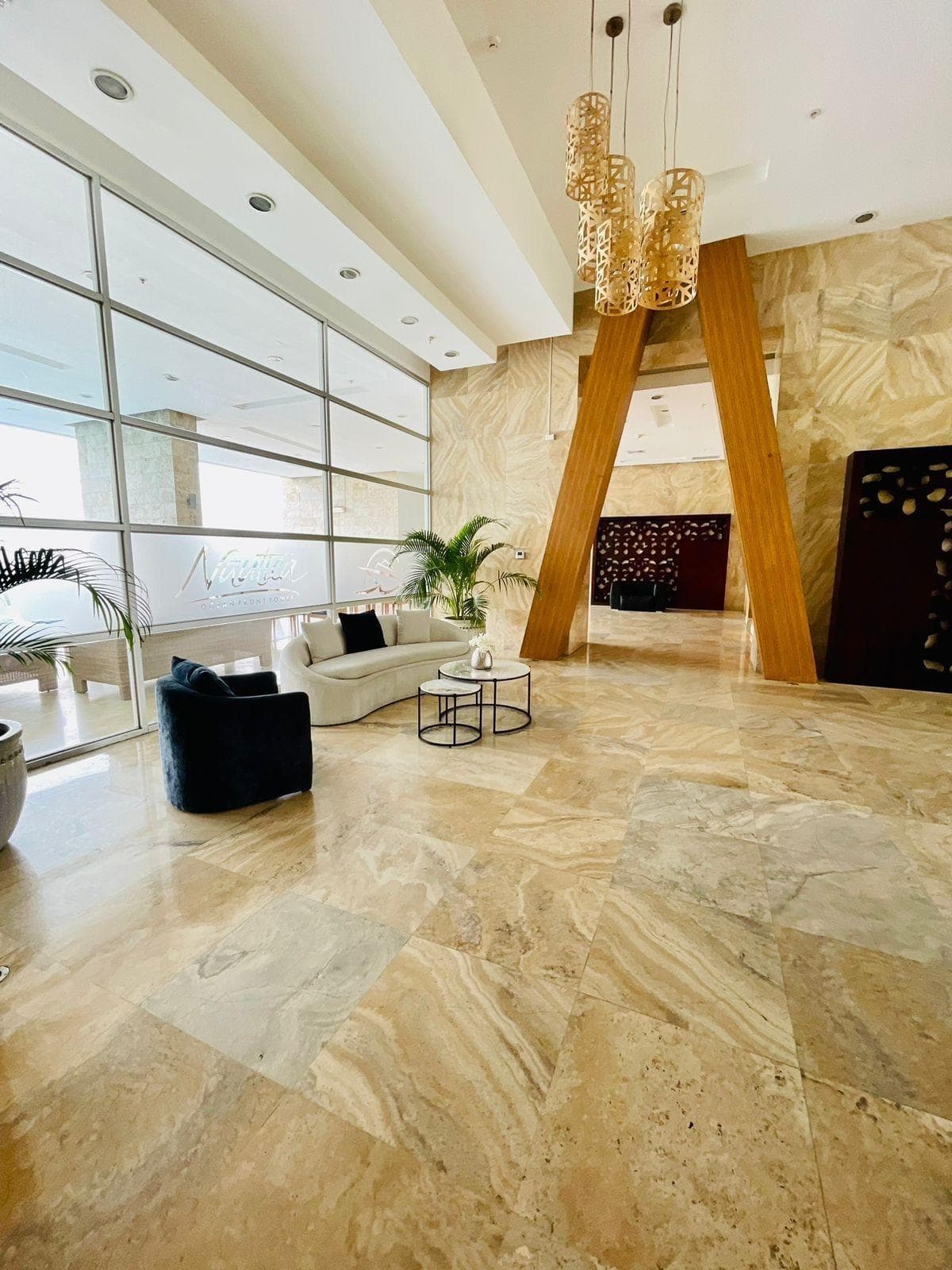 Double-height marble lobby of the Nautica tower in Coco del Mar