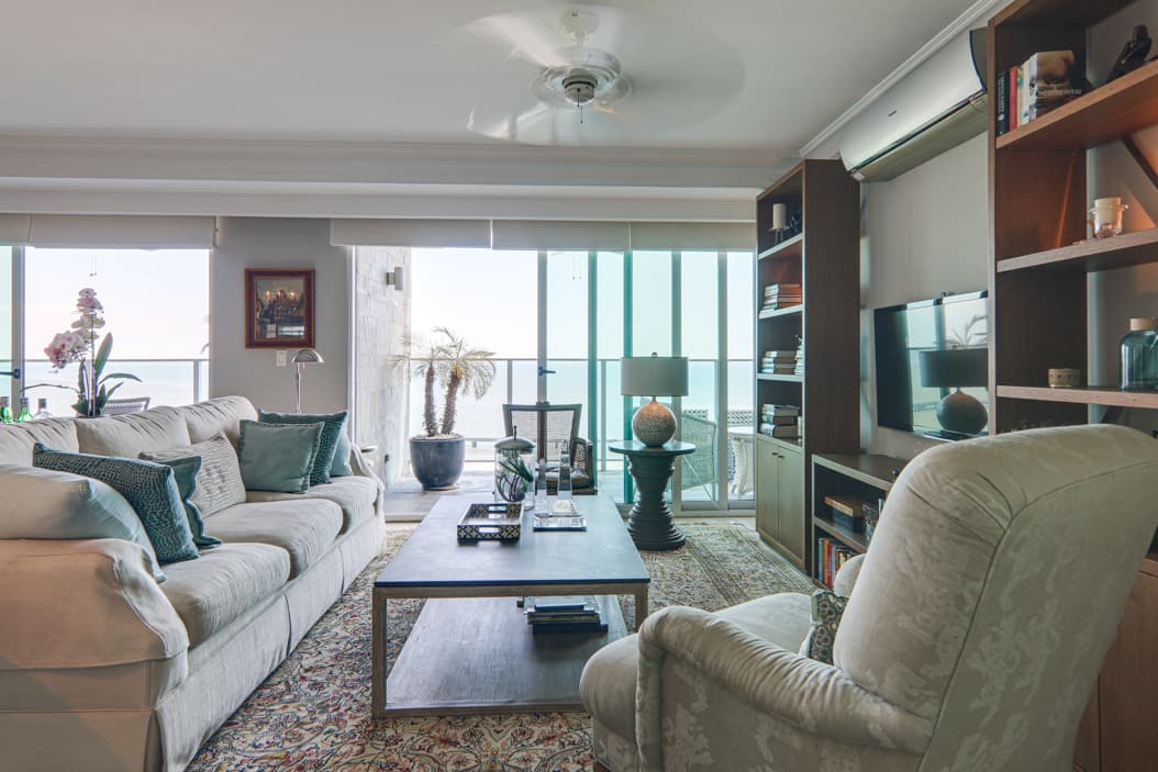 Living room of a Nautica apartment with floor-to-ceiling windows over the bay