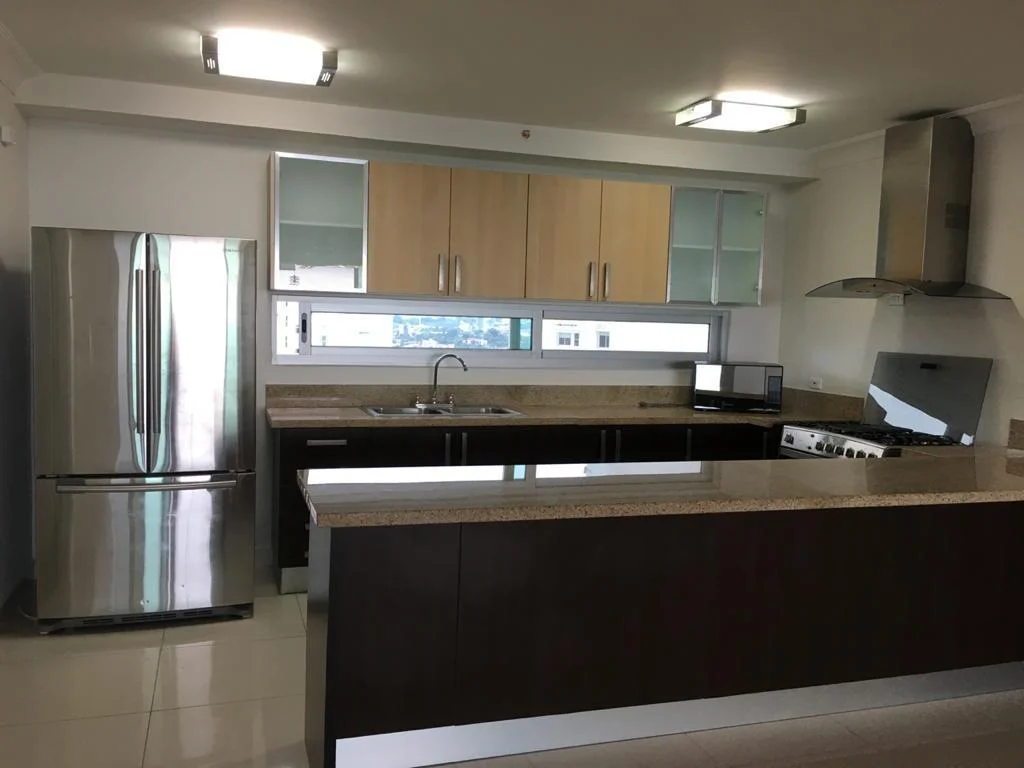 Open kitchen with stainless steel appliances in a Nautica apartment