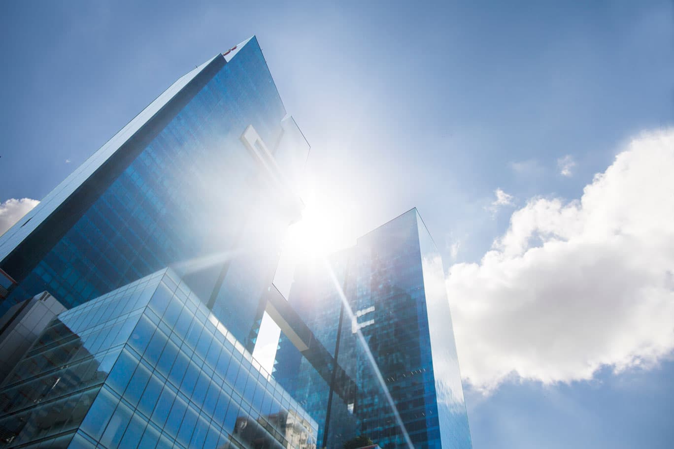 Oceania Business Plaza blue glass facade rising against the sky