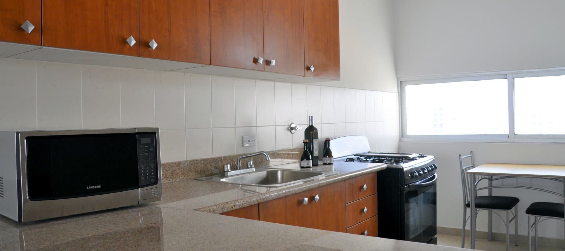 Torres Terrasol apartment kitchen with granite countertops