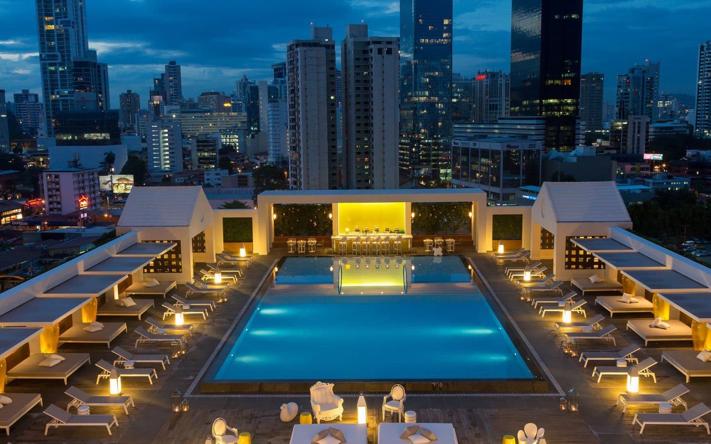 Rooftop swimming pool and cabanas above the Panama City skyline at Yoo Panama & Arts Tower