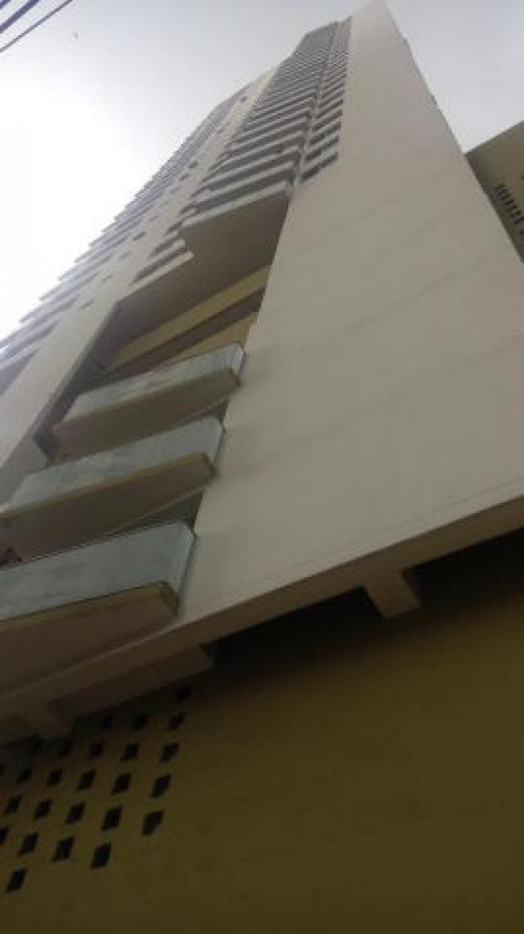 Upward view of the Marina Terrace residential tower facade with its balconies and perforated panels, Bella Vista, Panama City
