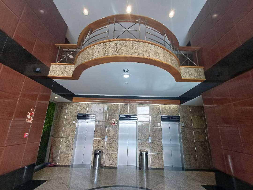 Elevator lobby with granite walls and a curved mezzanine balcony in the Hi-Tech Plaza building, Obarrio, Panama City