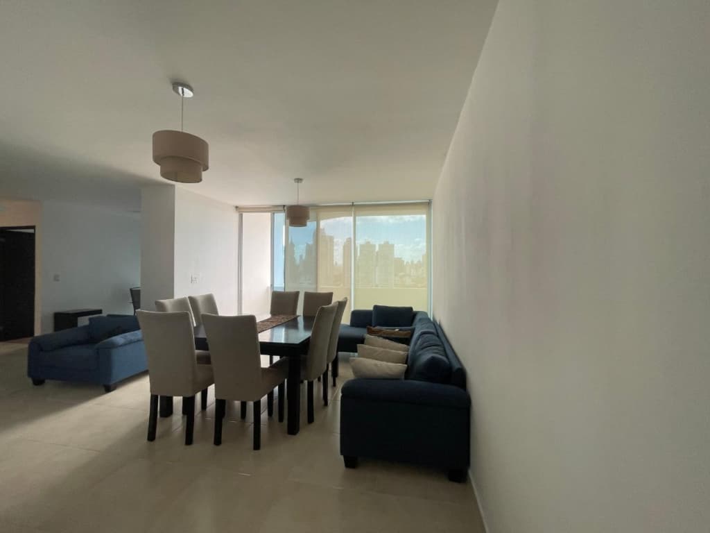 Living and dining room with a view of the city in an apartment at PH Infinity, San Francisco, Panama City