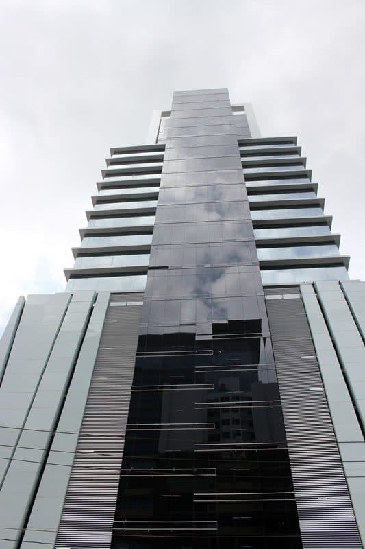 Upward view of the stepped glass facade of PDC Panama Design Center
