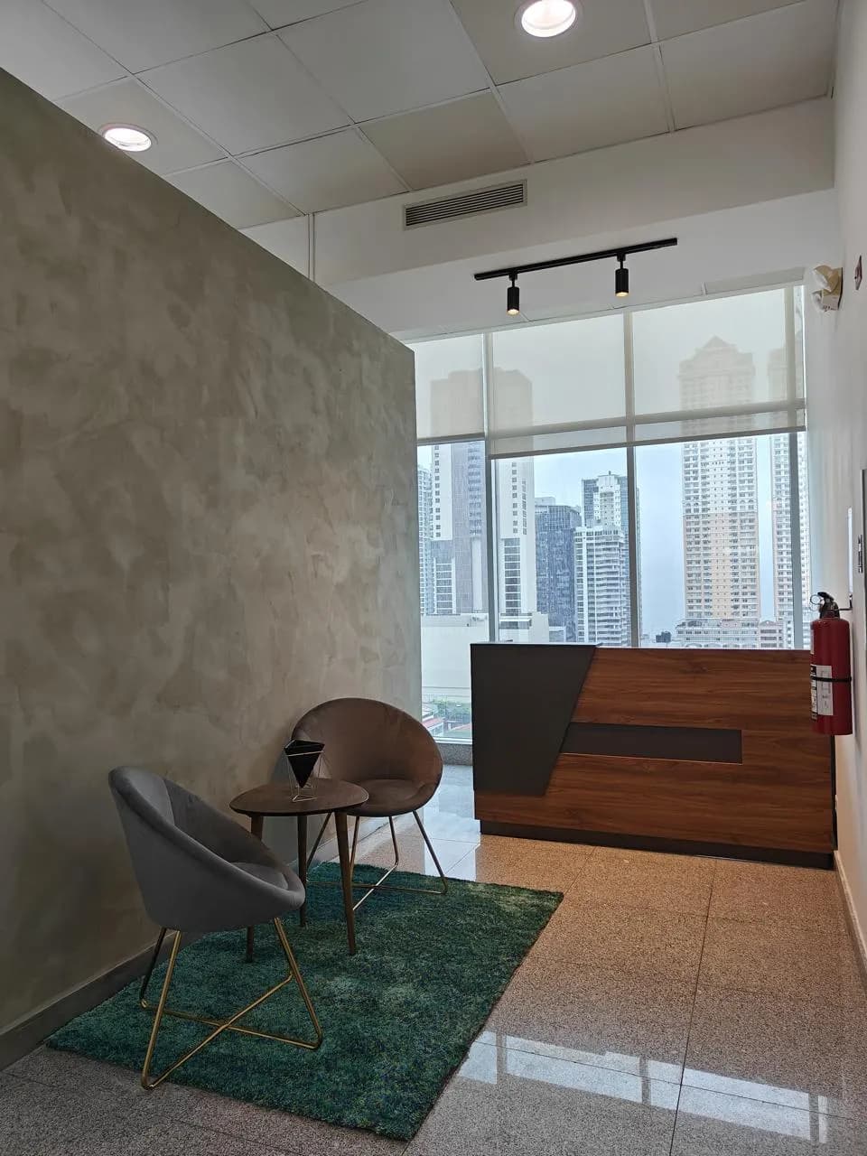 Office reception with lounge chairs and city-view windows in Habitats Plaza, Calle 51, Marbella, Panama City