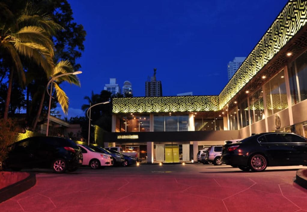 SF 69 Plaza at dusk, its patterned lattice canopy glowing above the storefronts, San Francisco, Panama City
