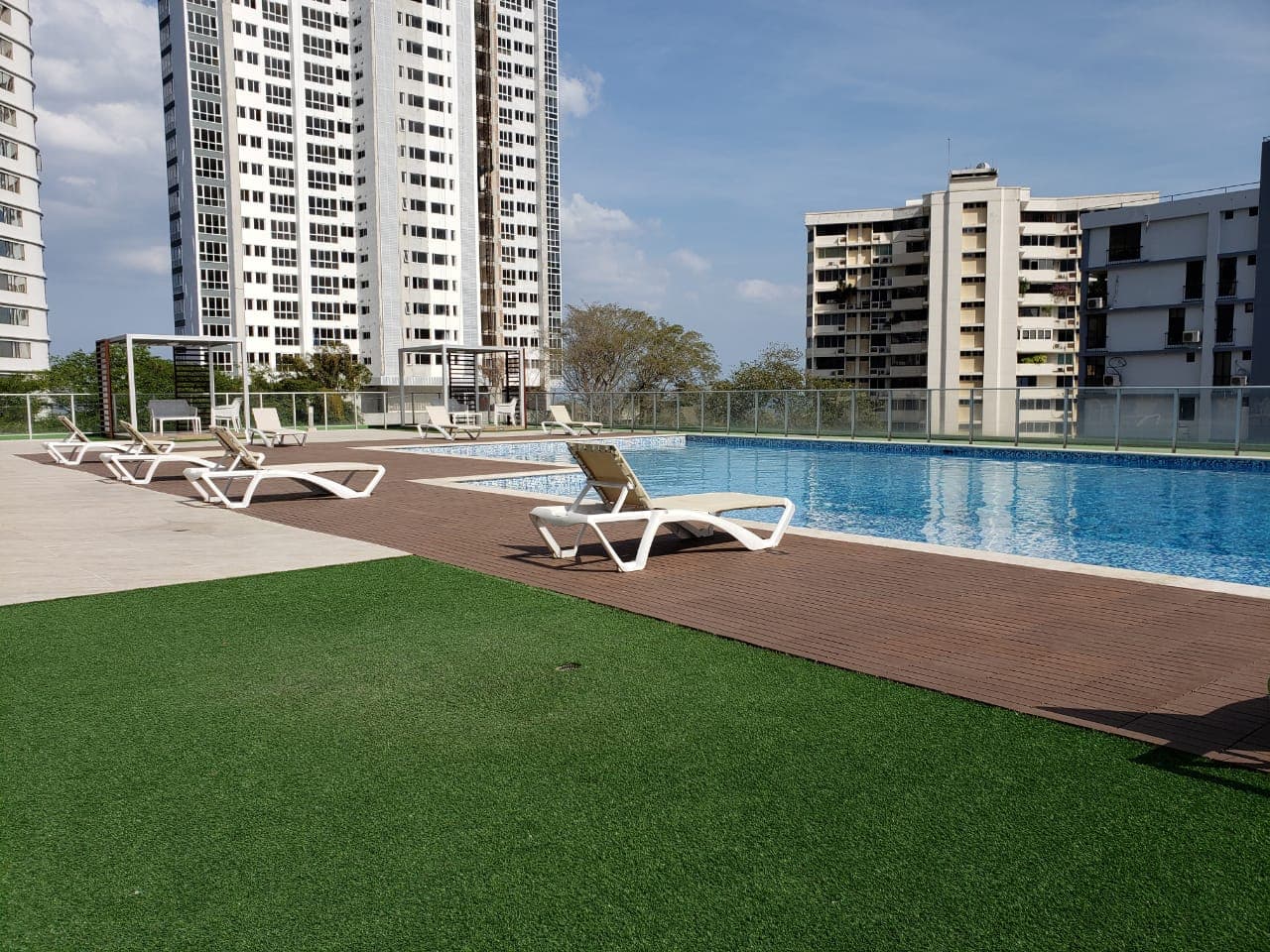 Pool deck with loungers and artificial turf at PH Le Mare, Coco del Mar, Panama City