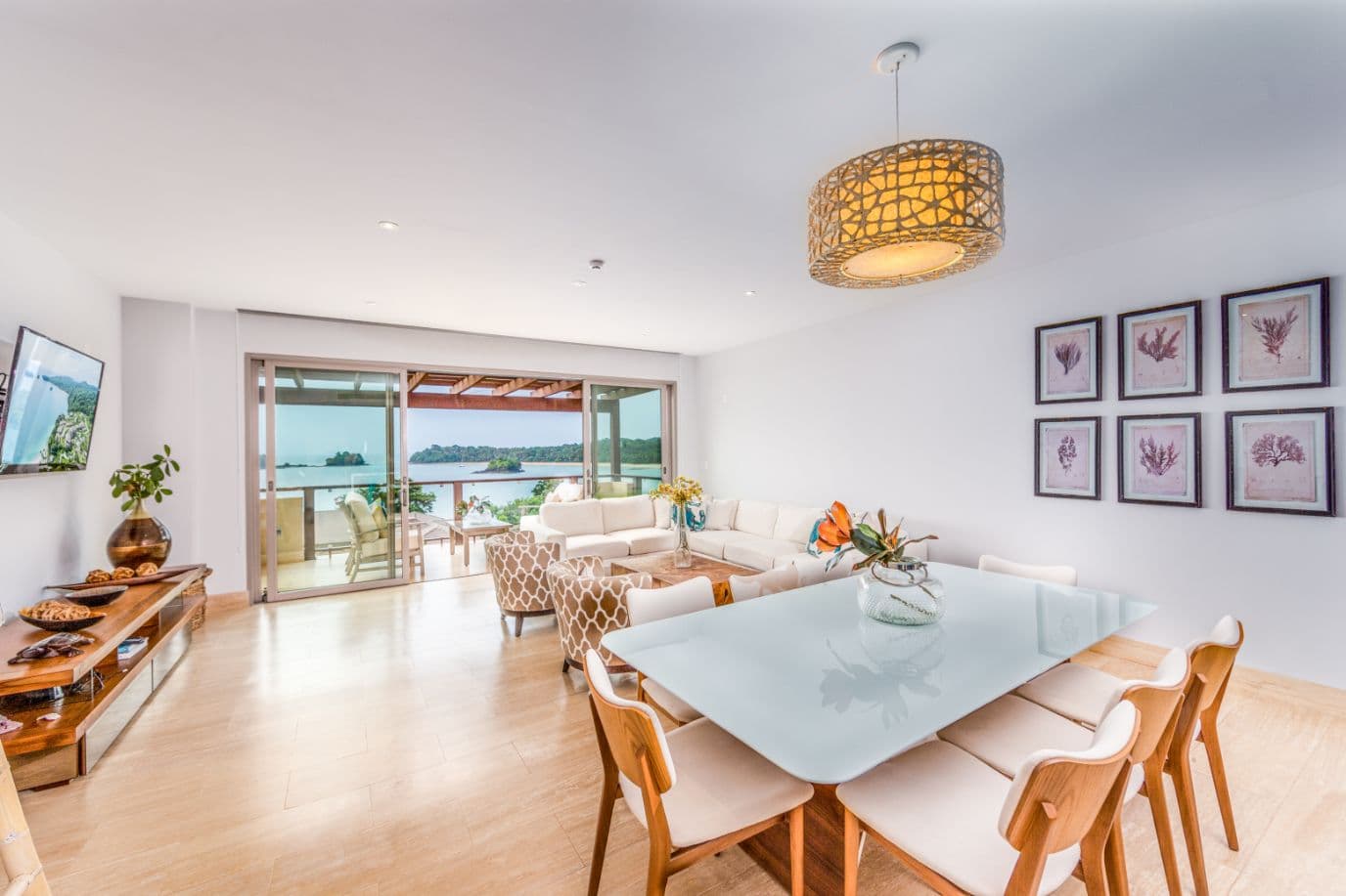 Living and dining room with ocean view in a La Peninsula Club Residence