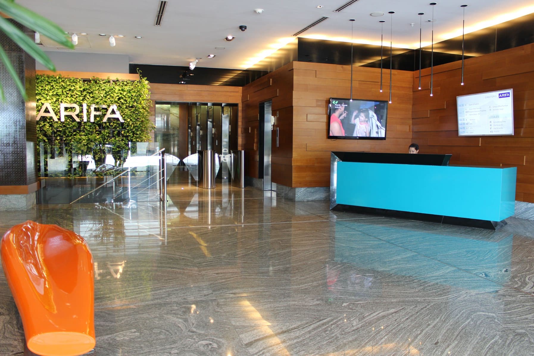 PH Arifa lobby with reception desk, marble floors and a green wall
