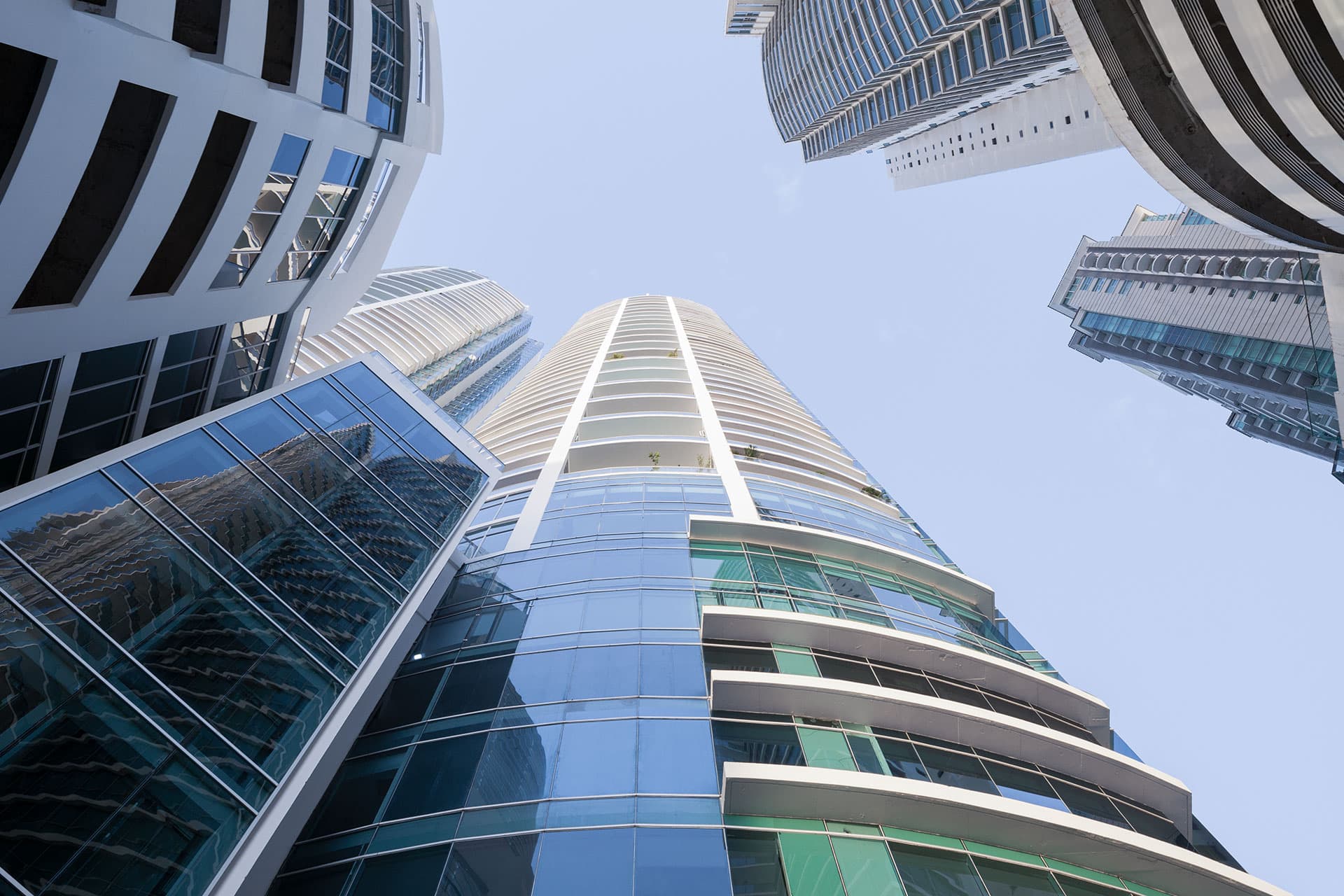Upward view of a Pacific Village glass and white tower in Punta Pacifica