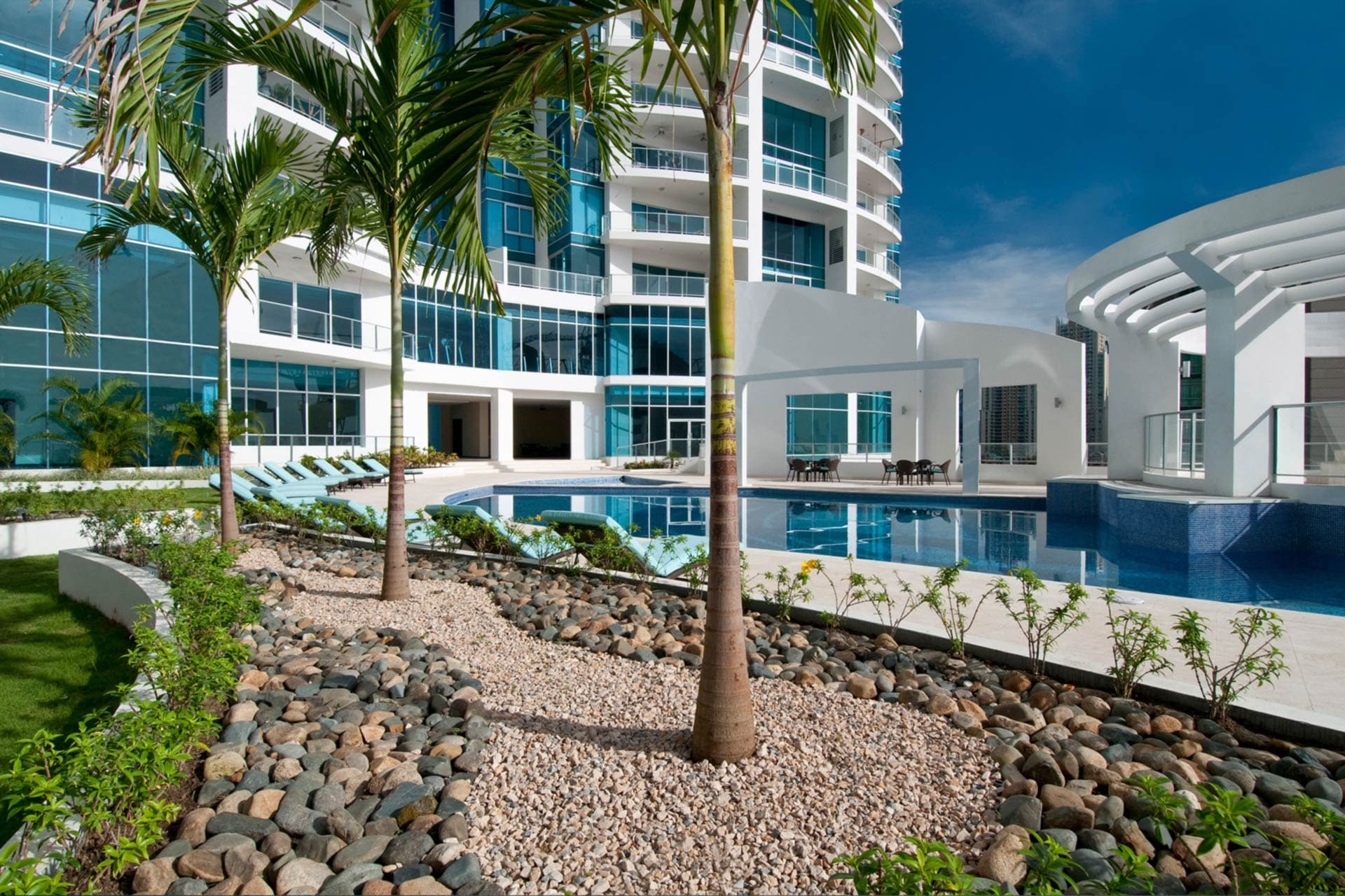 Landscaped garden and pool area between the Pacific Village towers
