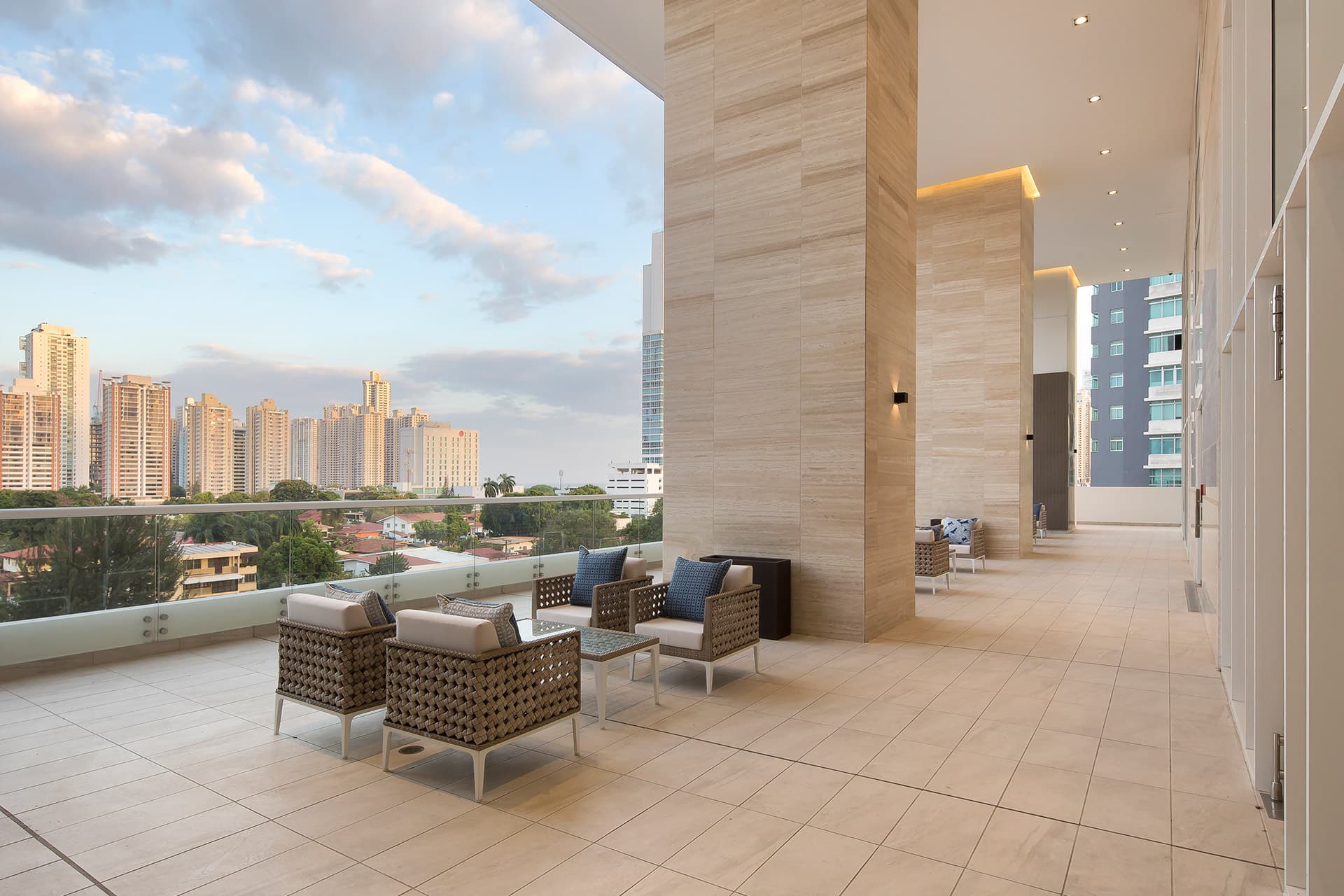 Covered terrace lounge with city views at The Towers Residences