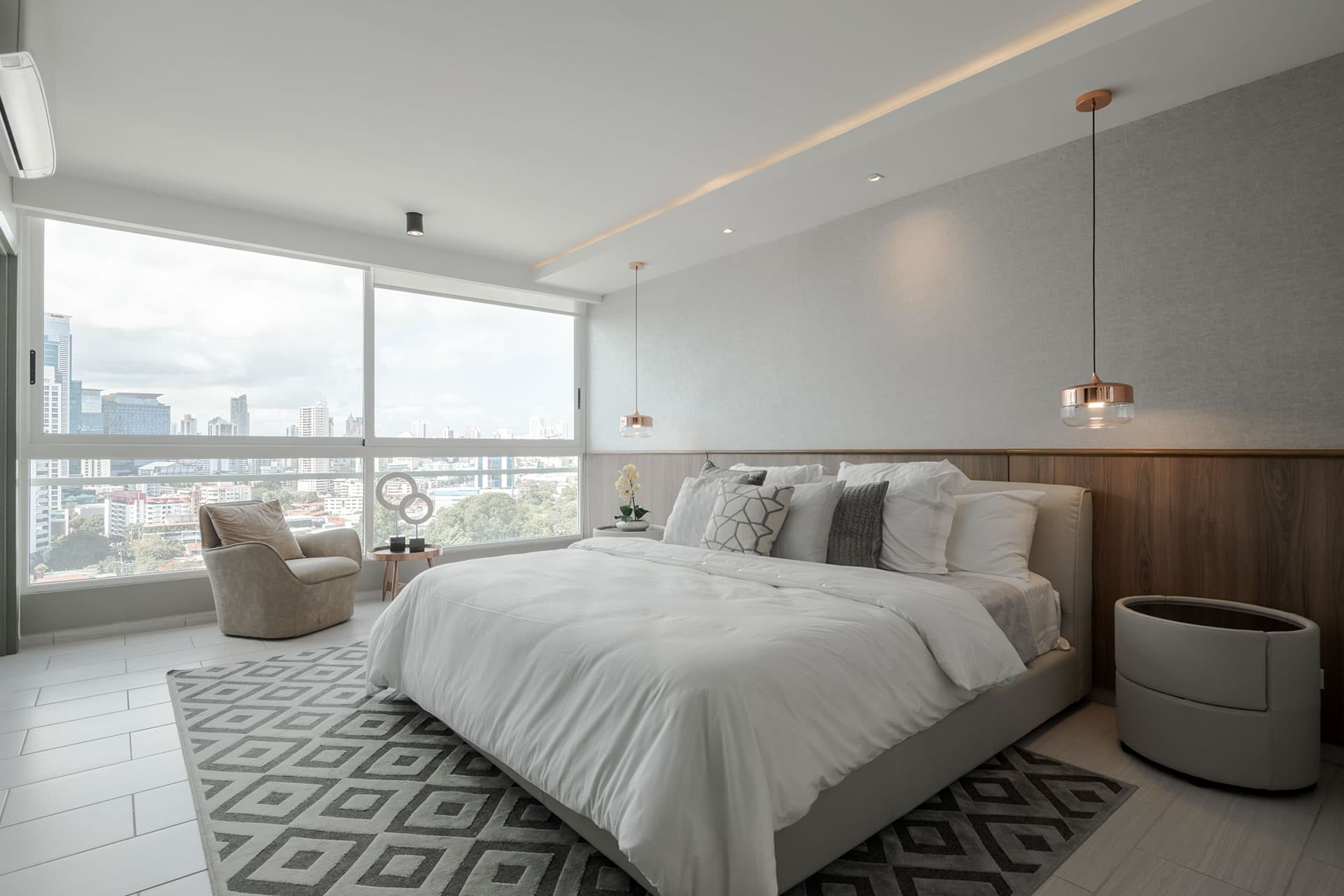 Primary bedroom with floor-to-ceiling window in a The Towers Residences apartment