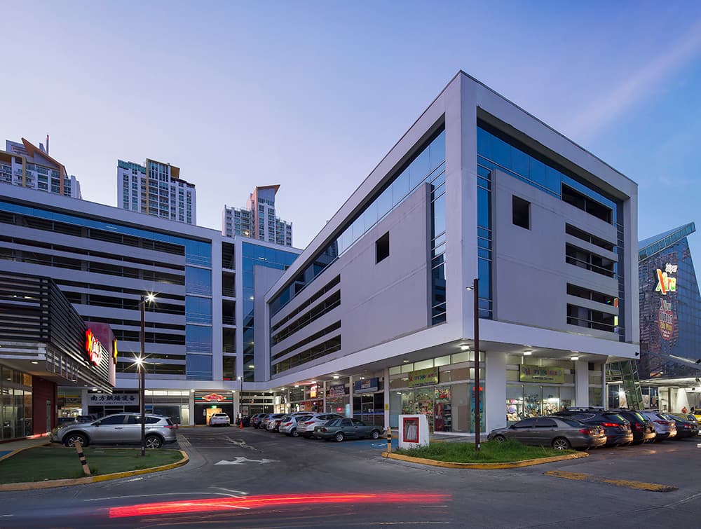 Condado Business Center office building and retail arcade at dusk in Condado del Rey