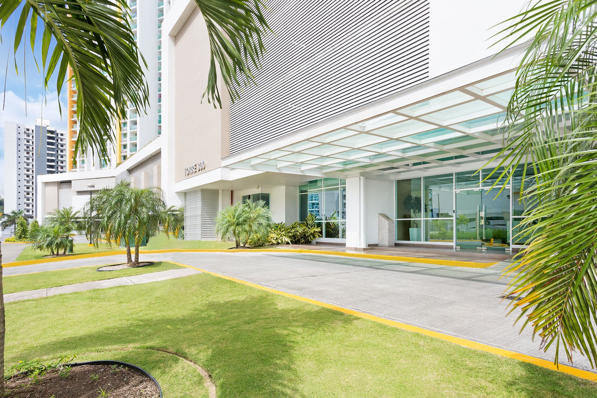 Tower entrance with lawn and palm trees at King's Park
