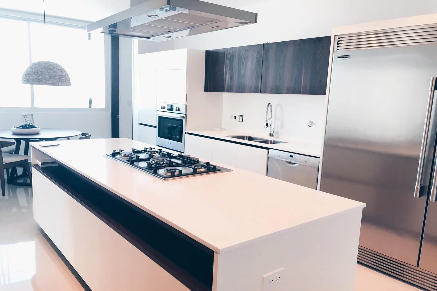 Kitchen with island cooktop and stainless appliances at Solana