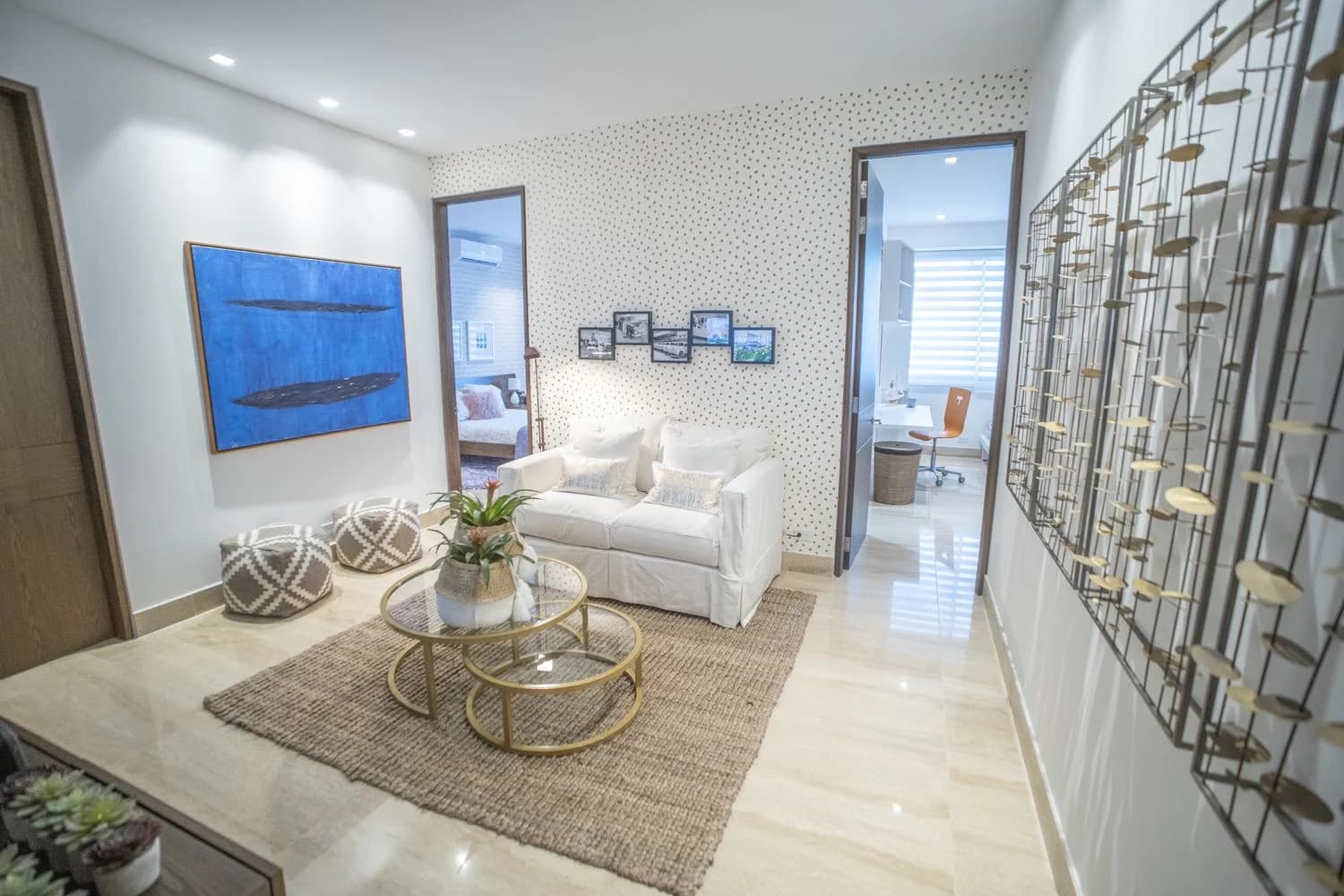 Den with sofa and artwork in a Solana apartment