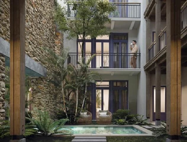 Rendering of the Patio San Miguel inner courtyard with a plunge pool beneath stone walls and balconies