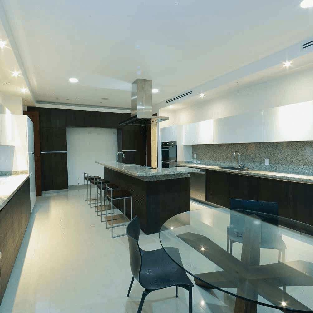 Aria apartment kitchen with dark cabinetry, island and breakfast bar