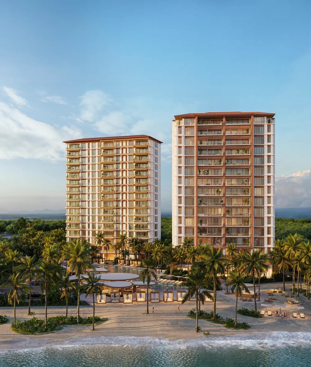 Alamar twin residential towers rising above palm trees and the beach in Buenaventura, Panama