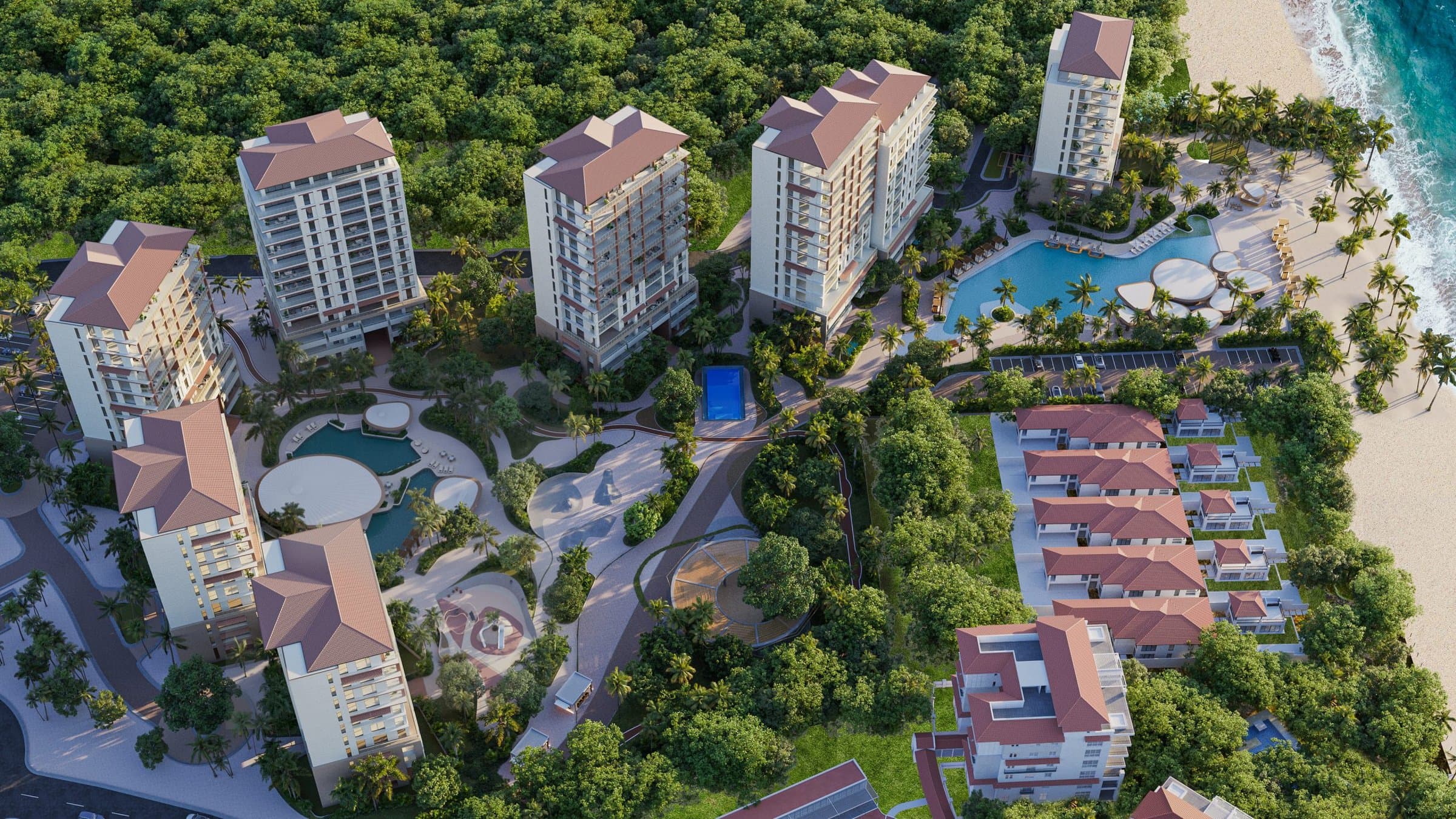 Aerial view of the Alamar towers, pools and gardens beside the ocean in Buenaventura