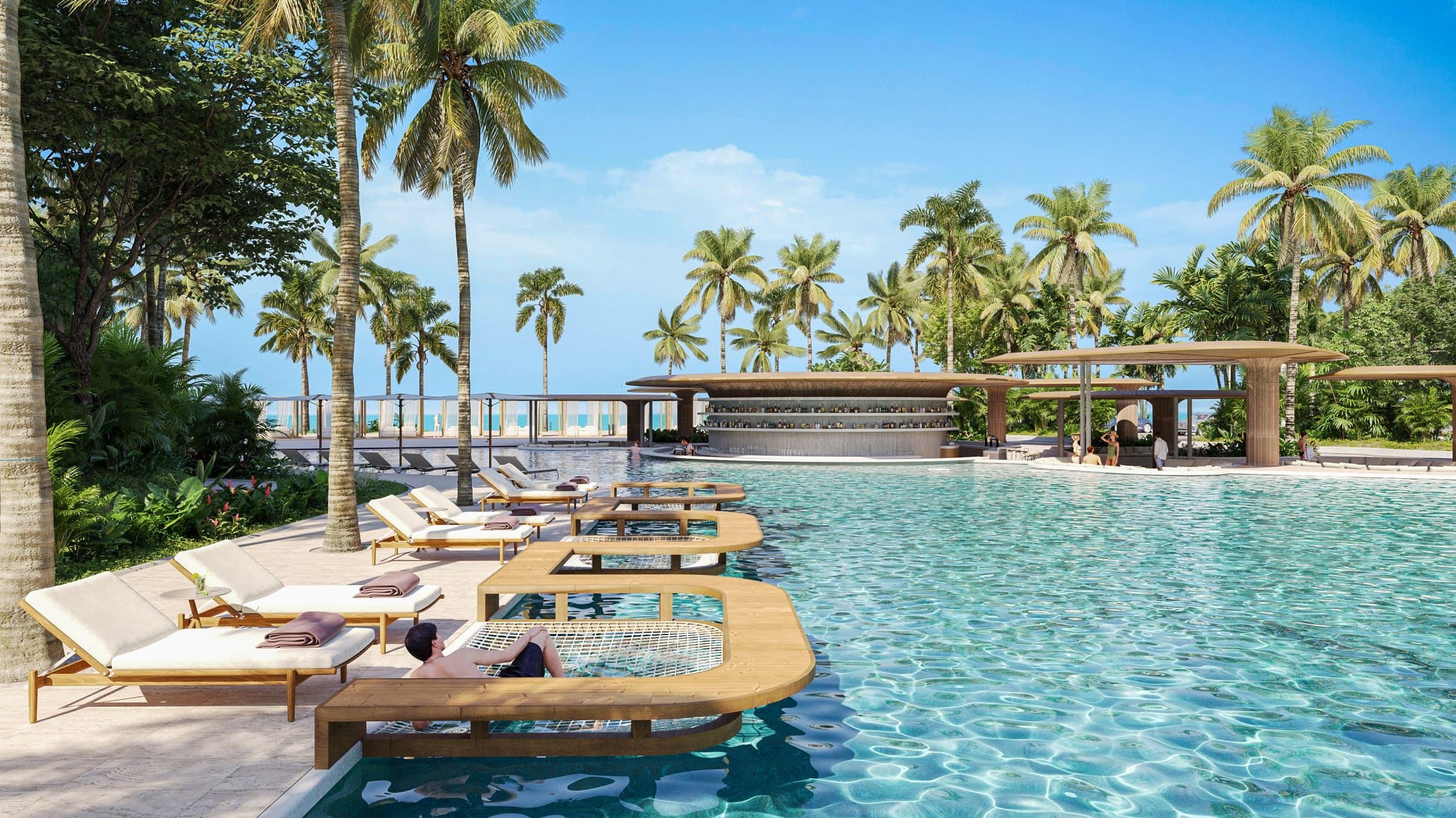 Alamar resort-style pool with sun loungers and palm trees facing the sea