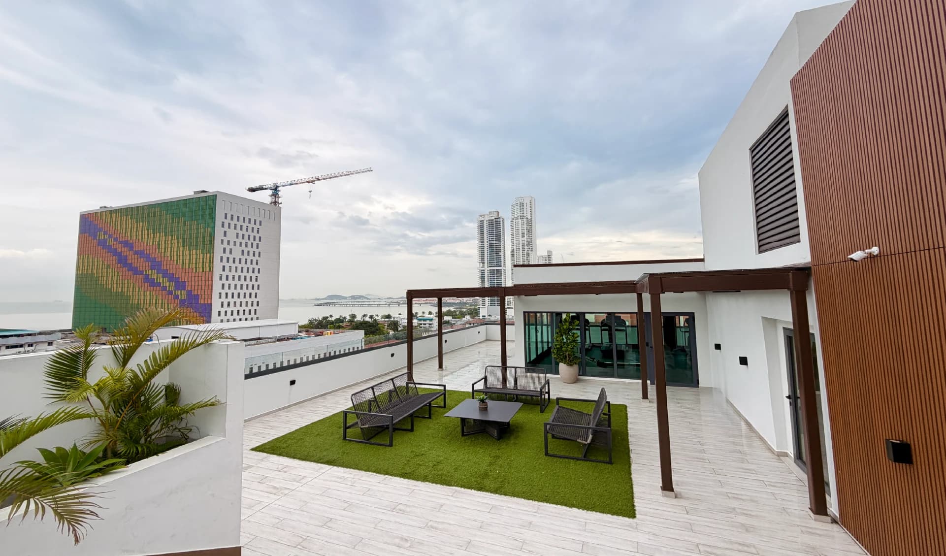 Rooftop terrace lounge with pergola and artificial lawn at Alexa Bella Vista