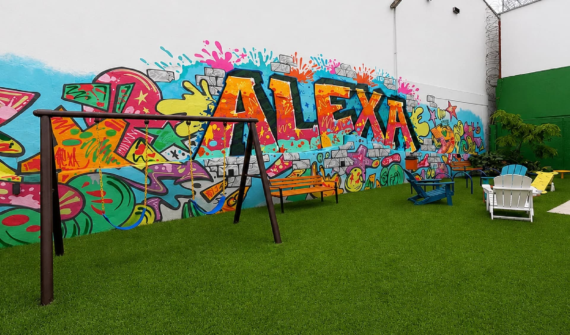 Pet garden with a swing bench and a colorful mural at Alexa Bella Vista