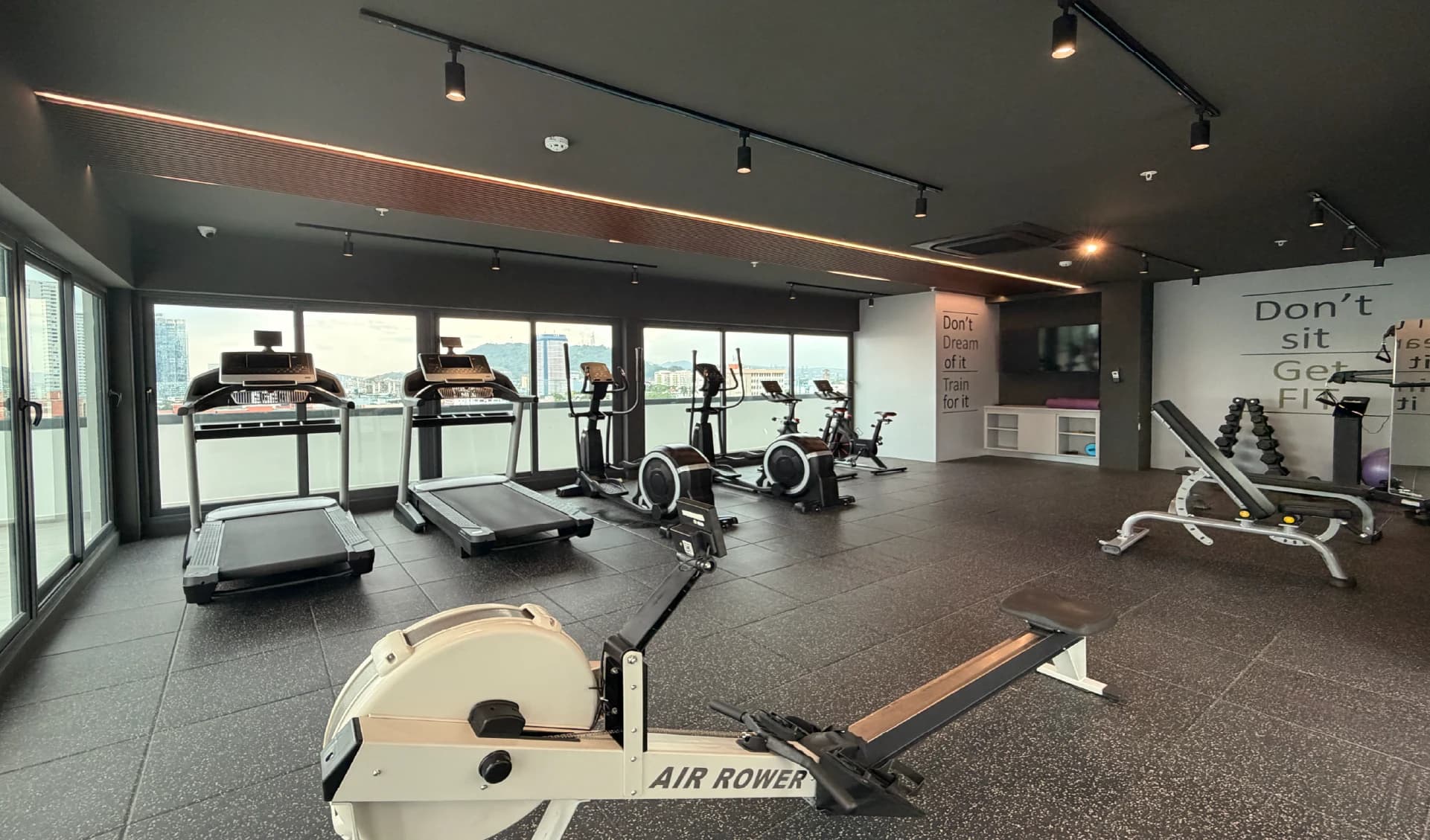 Fitness center with treadmills and city views at Alexa Bella Vista