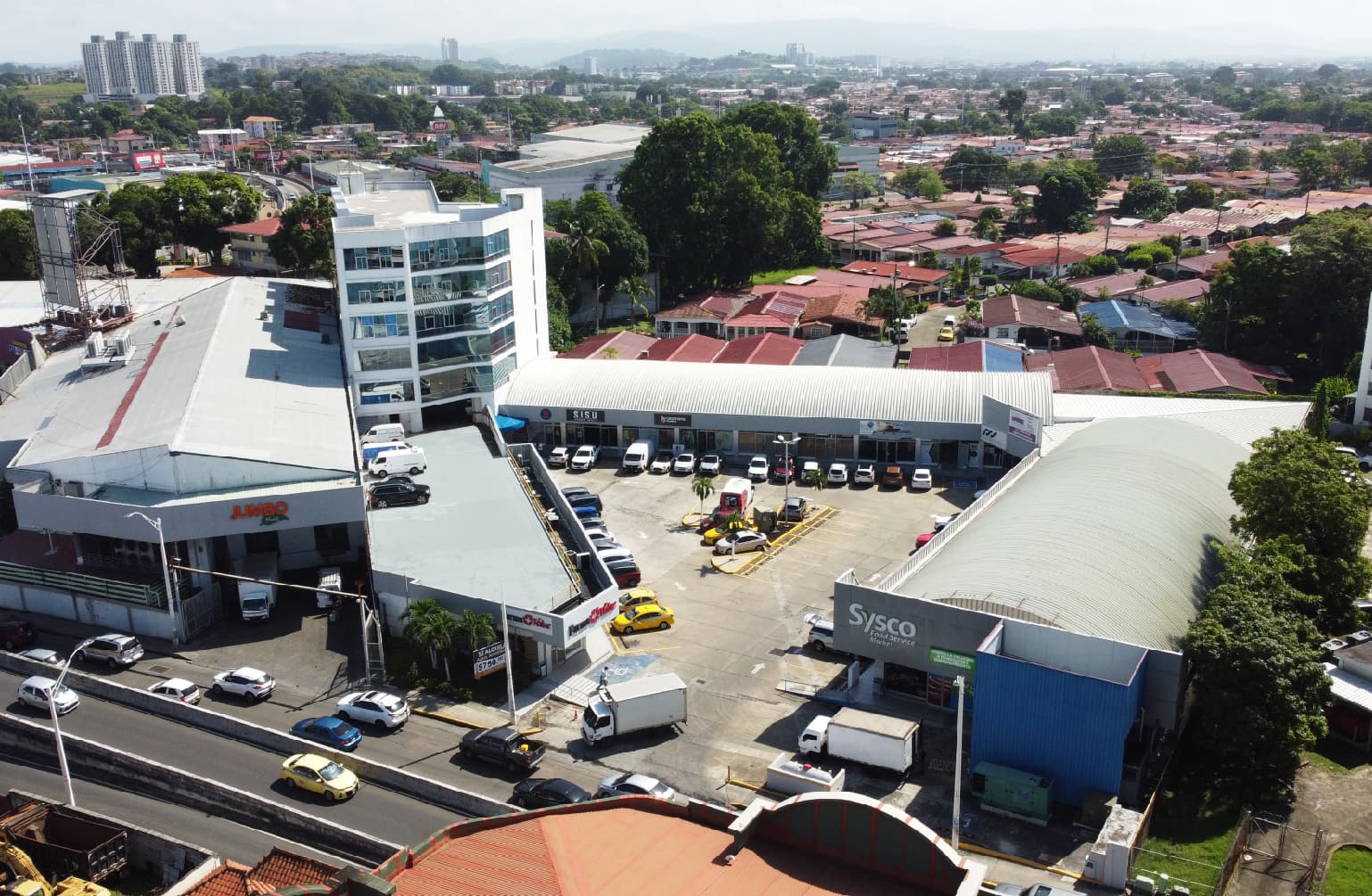 Aerial view of Centro del Este with its office building, parking court and shops beside the Corredor Sur, Costa del Este