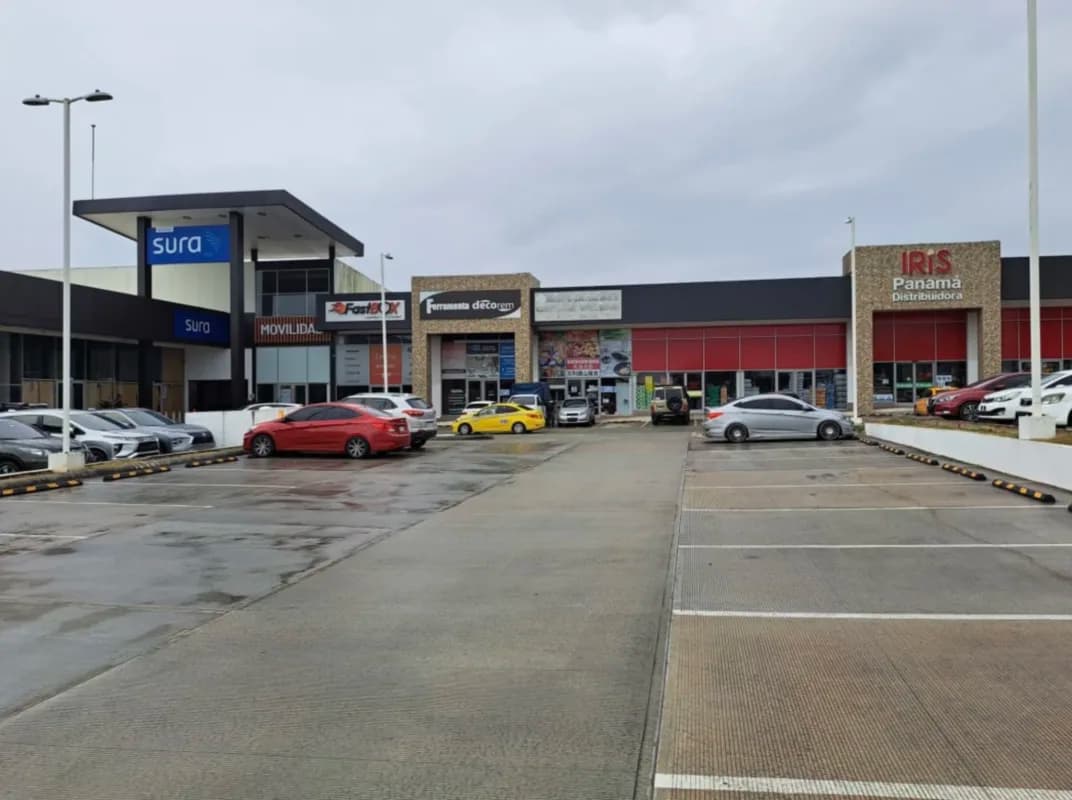 Uniplaza Costa Verde retail frontage with tenant signs and parking