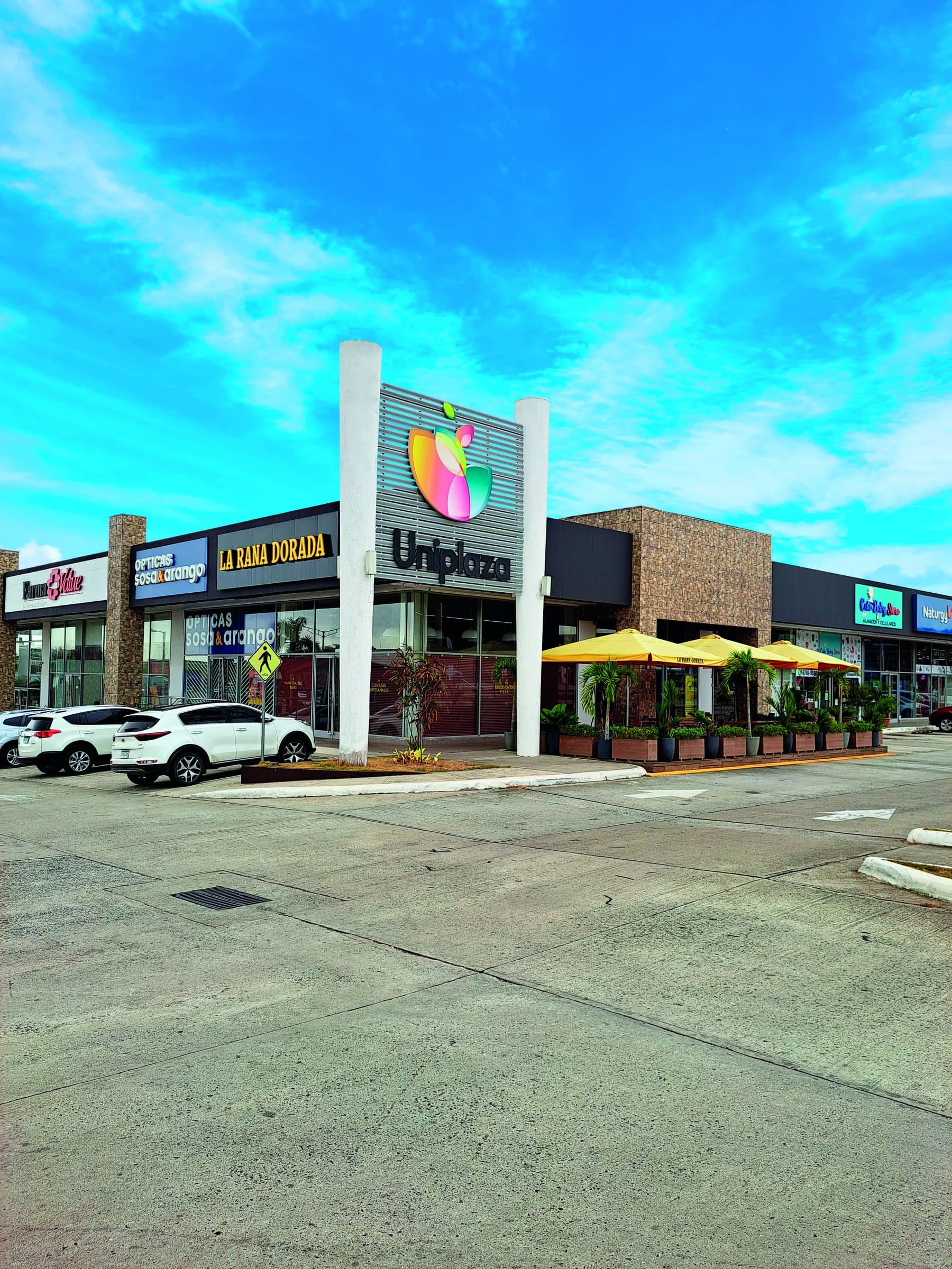 Uniplaza Costa Verde shopping plaza entrance with its pylon sign and storefronts, La Chorrera