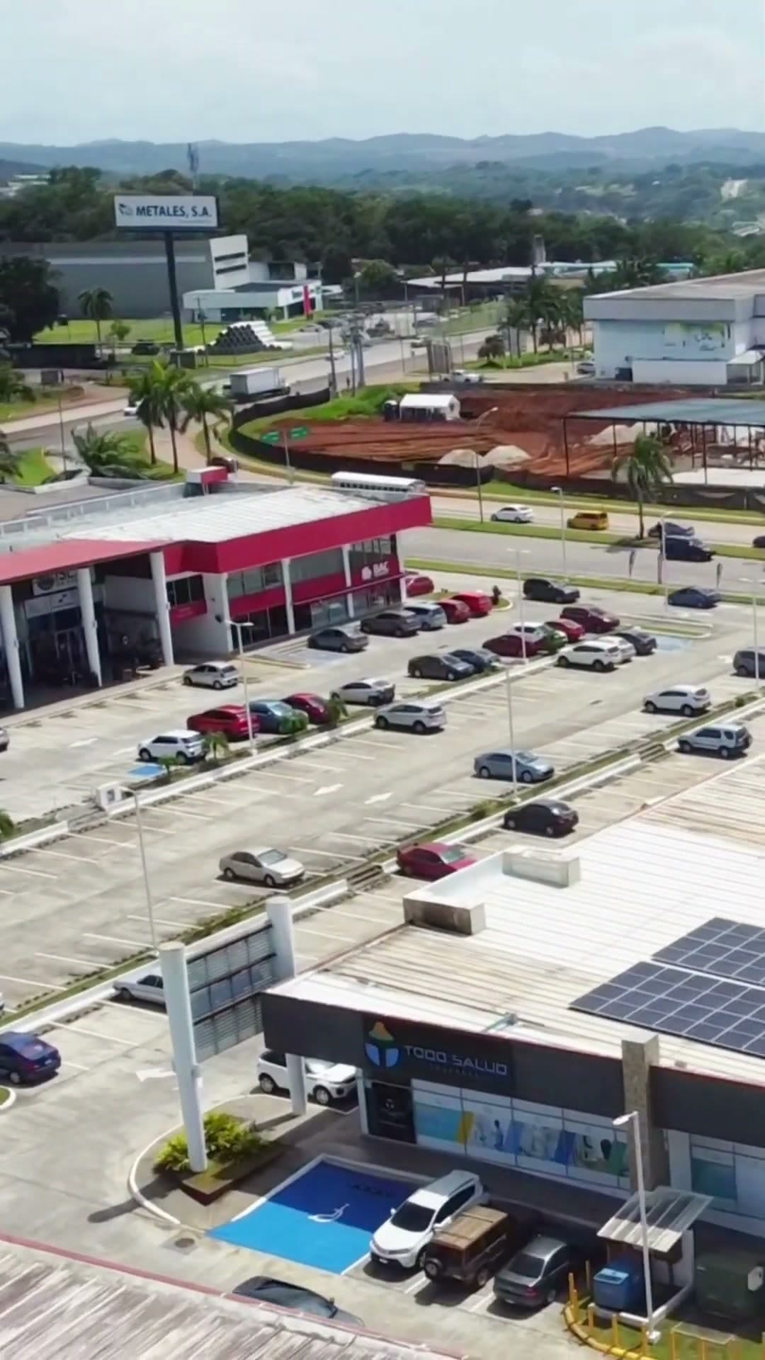 Drone view over the Uniplaza Costa Verde parking court and storefronts