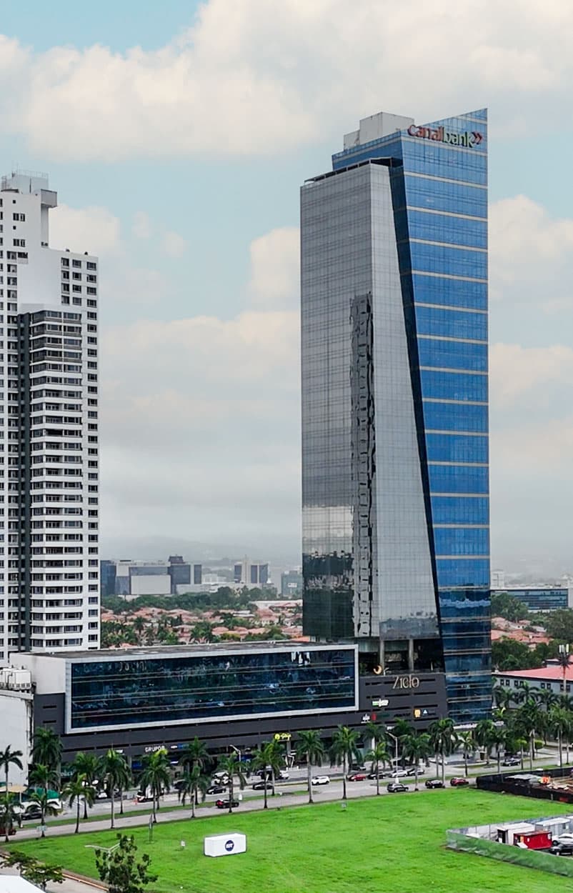 Times Square Center glass office tower rising over the green of Costa del Este, Panama City
