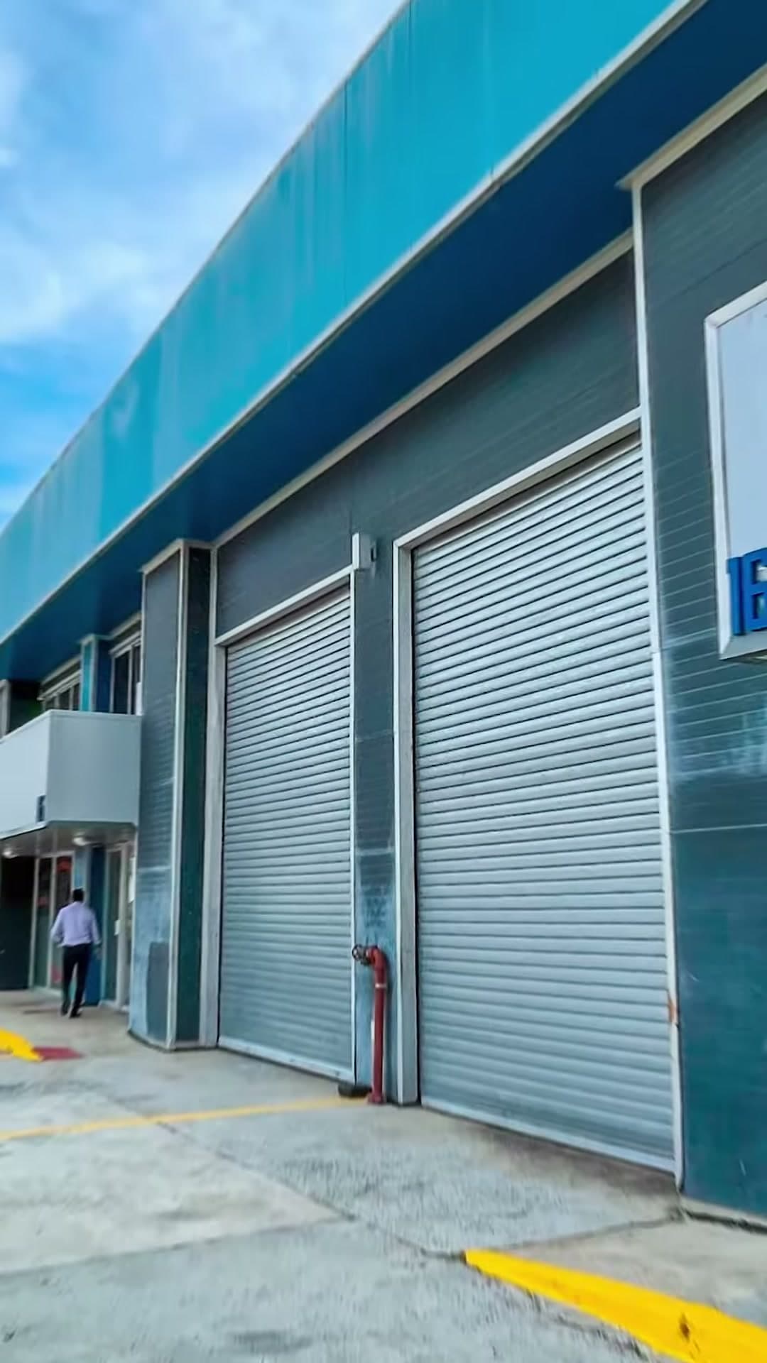 Warehouse unit 16 with roll-up doors and office front at Tocumen Office Storage, Tocumen, Panama City