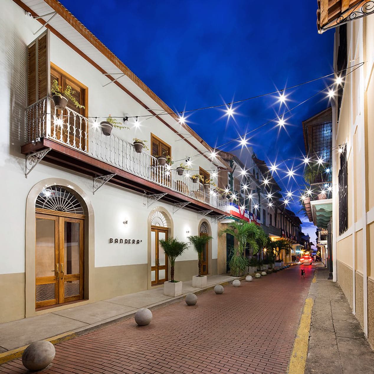 Restored Dekel building on a lamp-lit pedestrian street in Casco Viejo at dusk