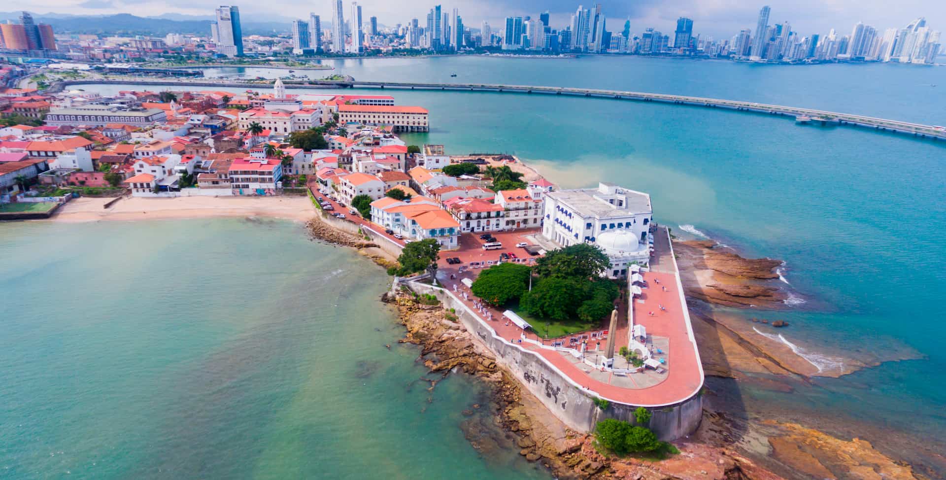 Aerial view of the Casco Viejo peninsula, home of the Dekel Casco Viejo Portfolio, with the Panama City skyline behind