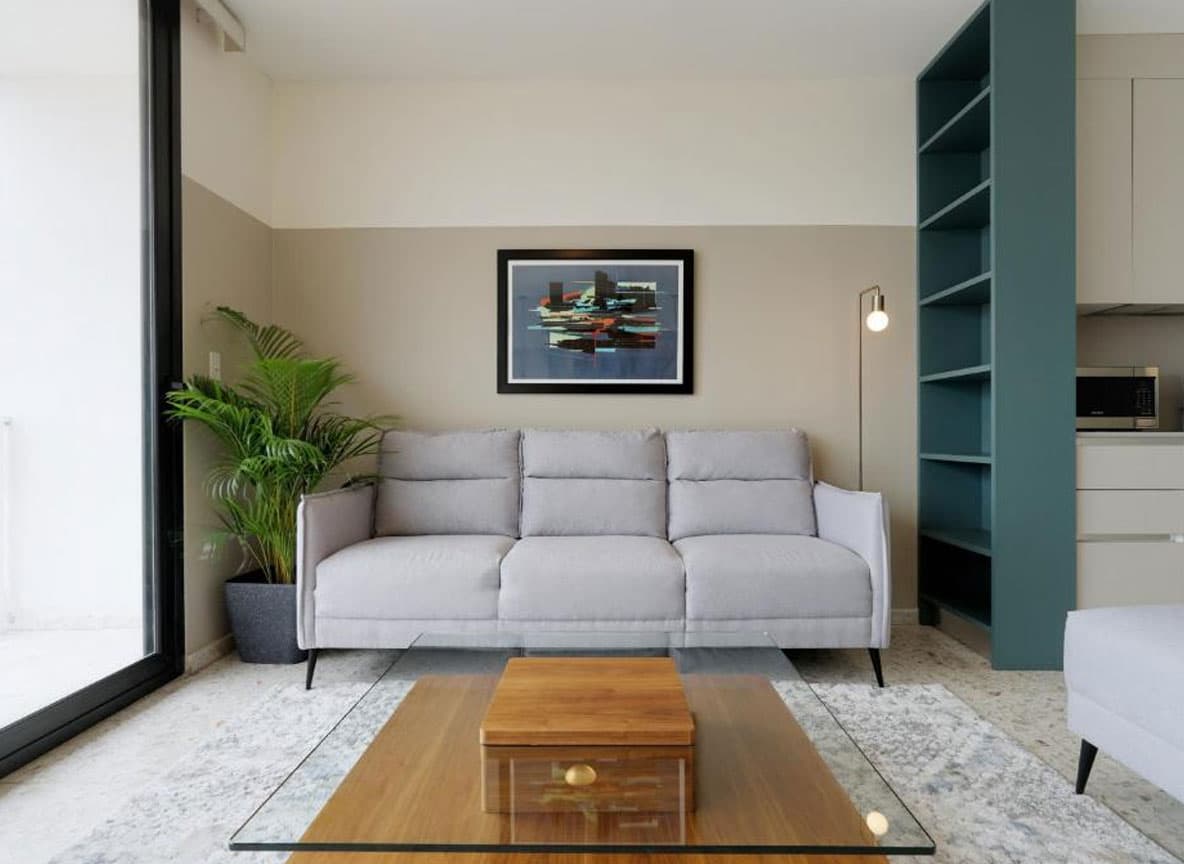 Furnished living room of a La Moderna apartment with terrazzo floors