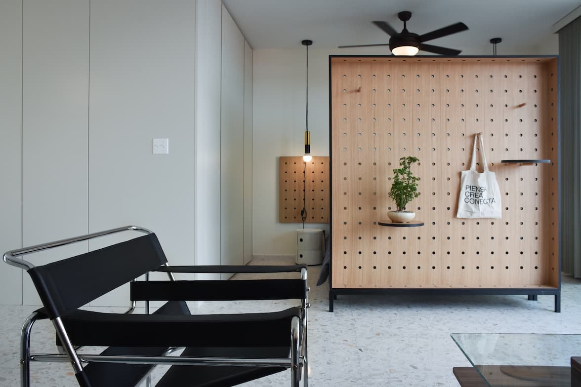 La Moderna apartment with pegboard room divider and ceiling fan