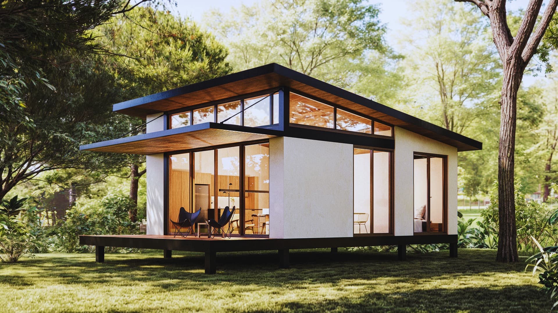 Rendering of a Vista Kaelo single-bedroom modular cabin with glass walls and a timber deck among trees