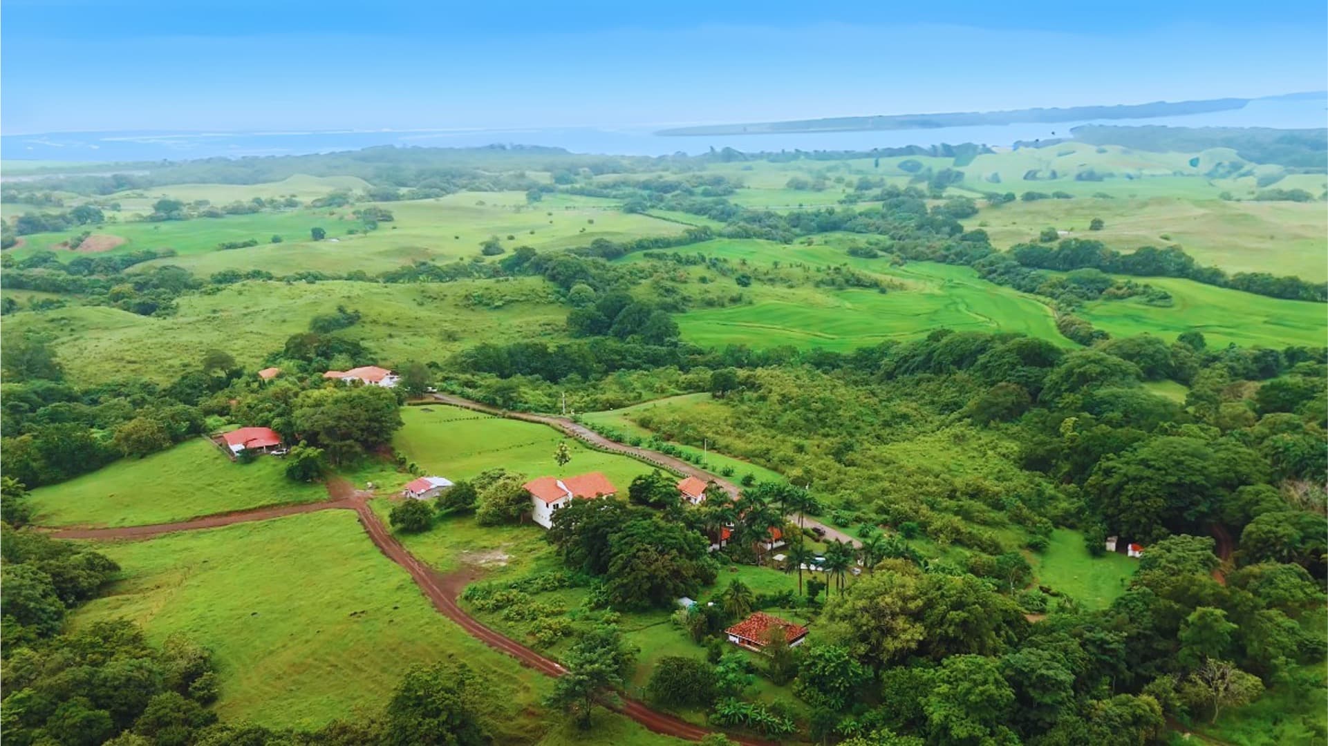 Aerial view of the rolling green Azuero hills and ocean horizon around the Vista Kaelo eco-village site