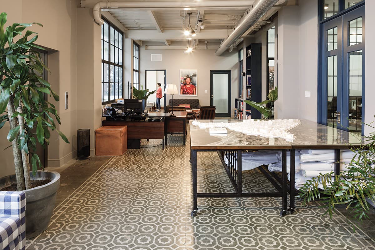 Open-plan office with patterned tile floor and high ceilings inside El Colegio II, Casco Viejo