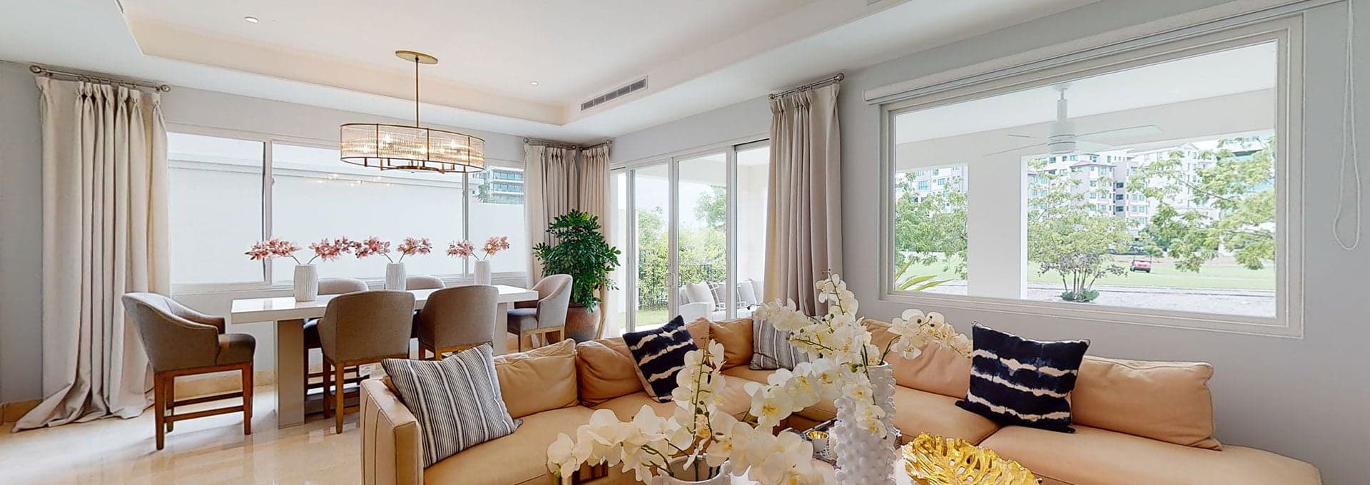 Living room with sectional sofa and open dining area overlooking the golf course in a home at The Crescent, Santa Maria
